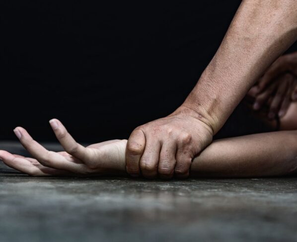 Imagem colorida de homem segurando braço de mulher, simulando violência contra a mulher - Metrópoles