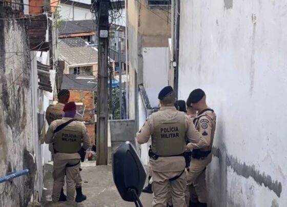 Imagem colorida de policiais em escadaria onde corpo de mulher trans foi encontrado - Metrópoles