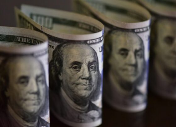 Imagem colorida de maços de notas de dólar norte-americano