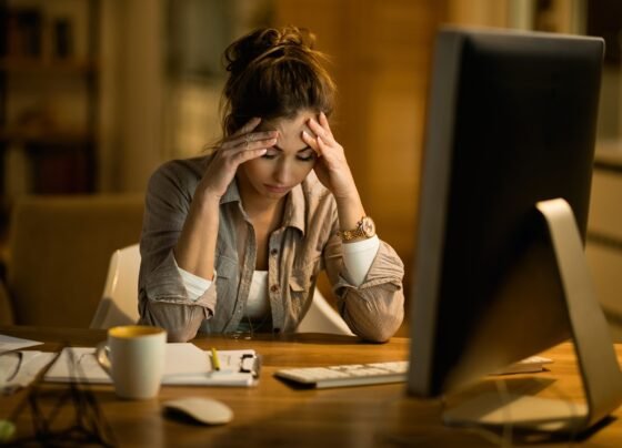 Foto colorida de mulher infeliz no trabalho - Psiquiatra explica o que é e como tratar depressão funcional - Metrópoles